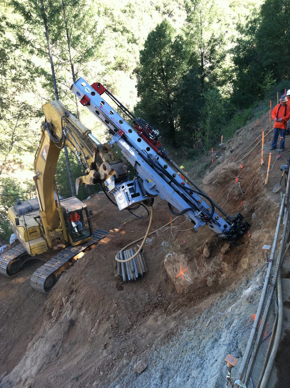 Excavator with drill attachment