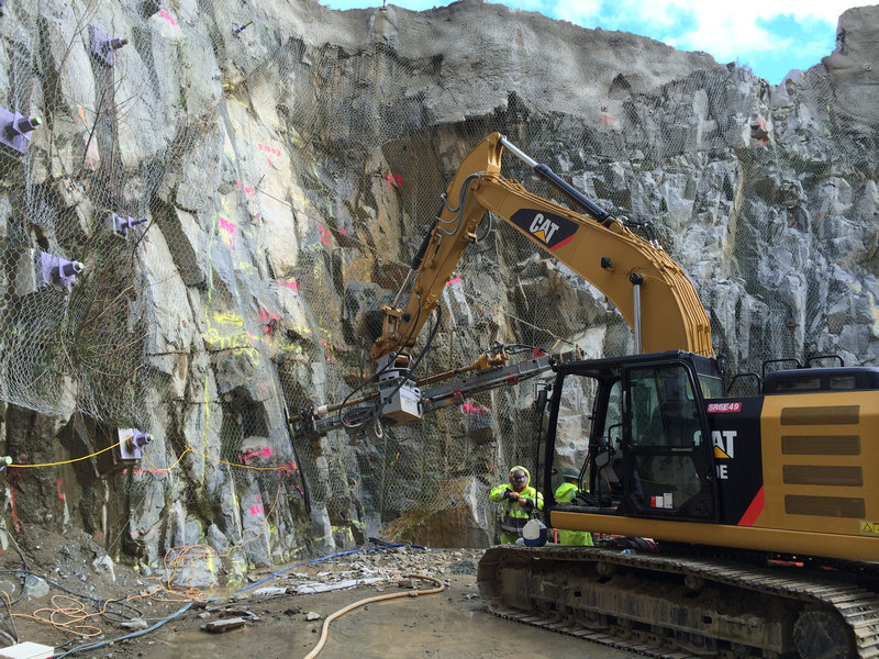 Excavator with drill attachment