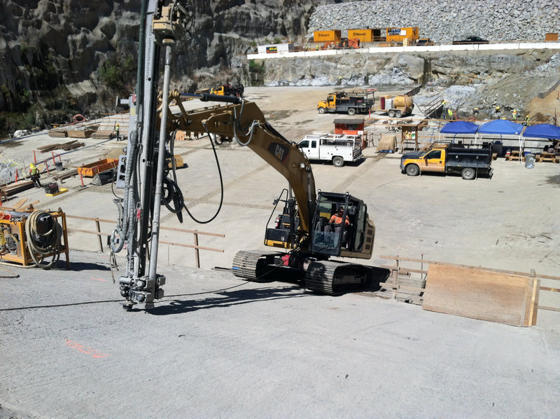 Excavator with drill attachment