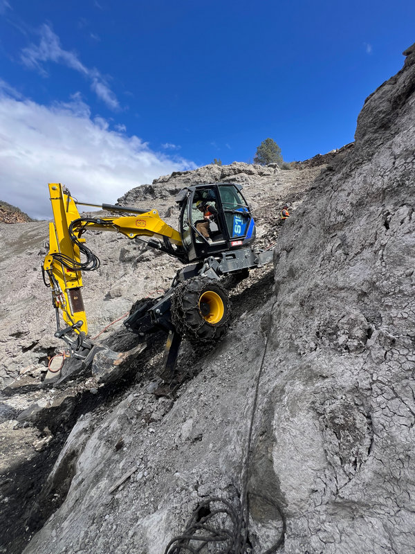 Spider excavator work on steep granite slope